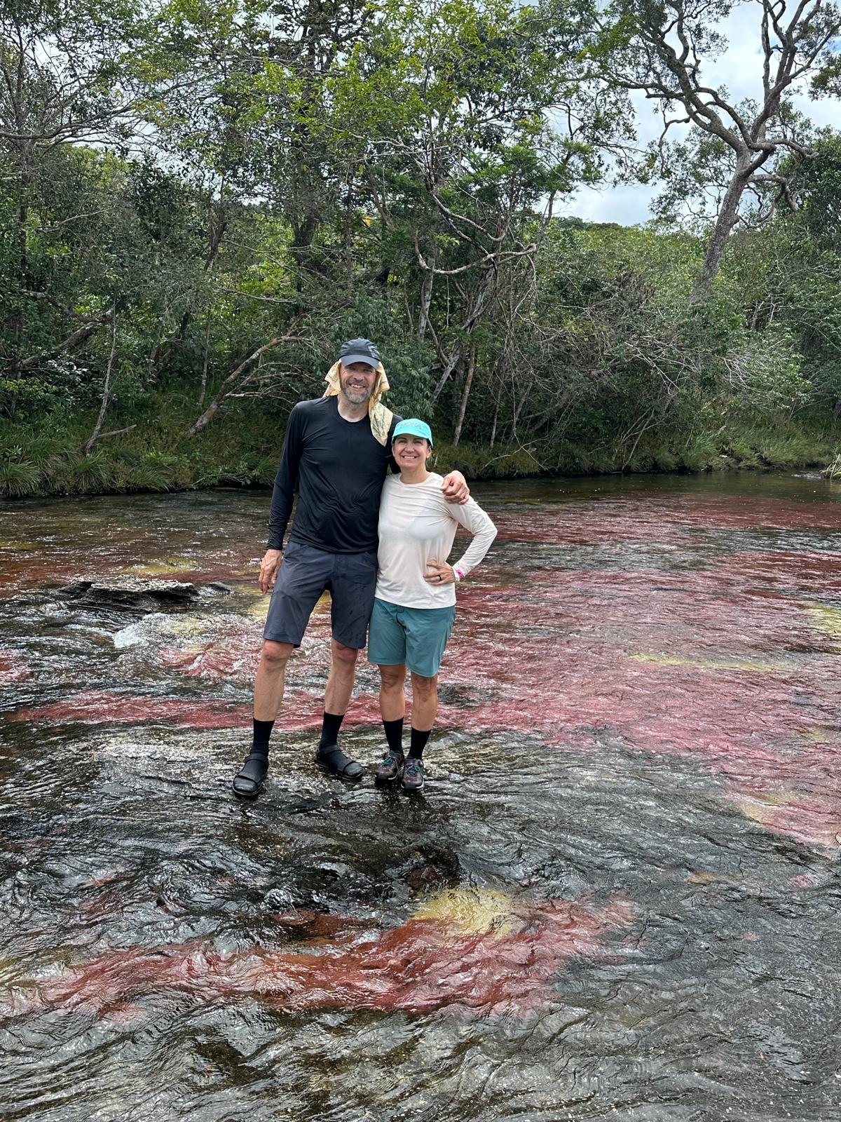 PL and Kristen standing together in a river
